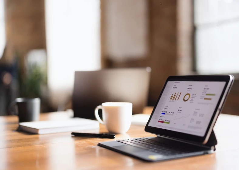 Coffee cup beside tablet in office scene