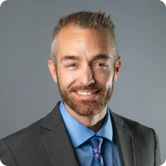 Man with a blue shirt and tie