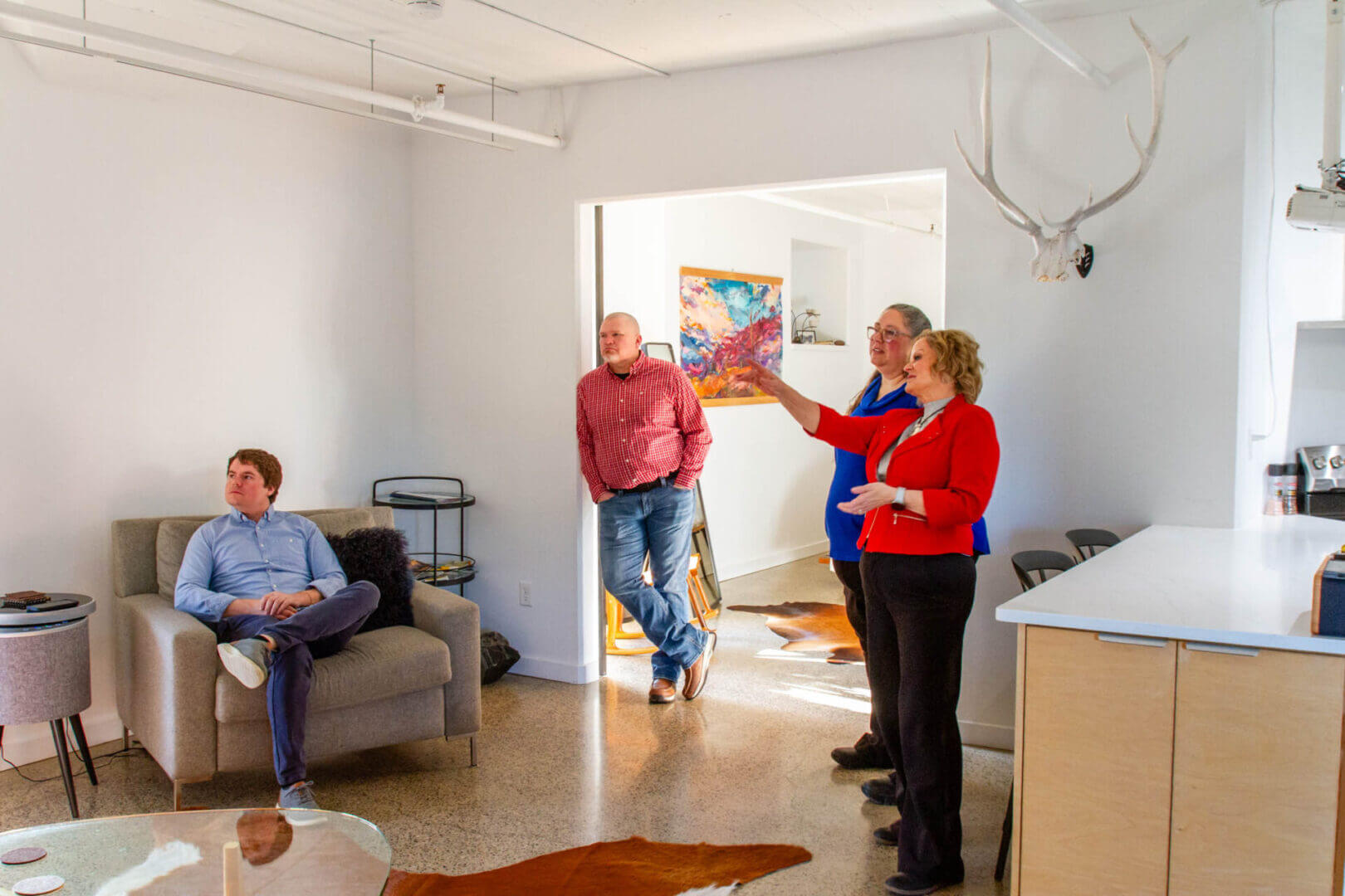 Group discussing in a modern living room.