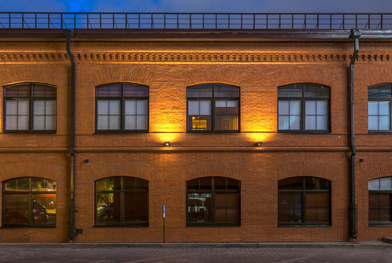 Brick building with illuminated windows at night.